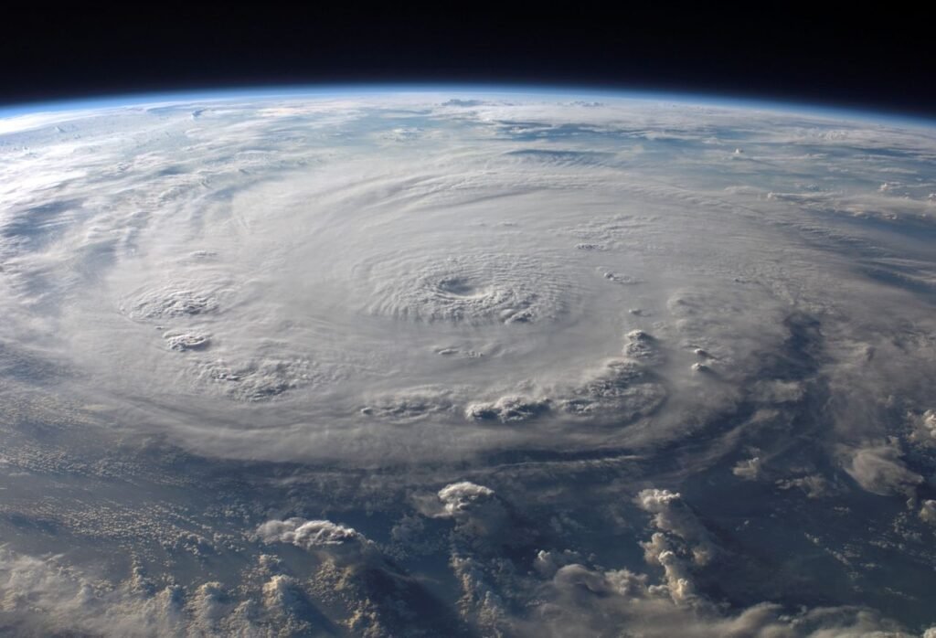 A stunning aerial view of Earth with a massive swirling hurricane, highlighting meteorological beauty.